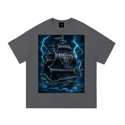 A dark gray crewneck t-shirt featuring a large graphic print of a pirate ship with the Oakland Raiders logo, surrounded by blue lightning bolts.