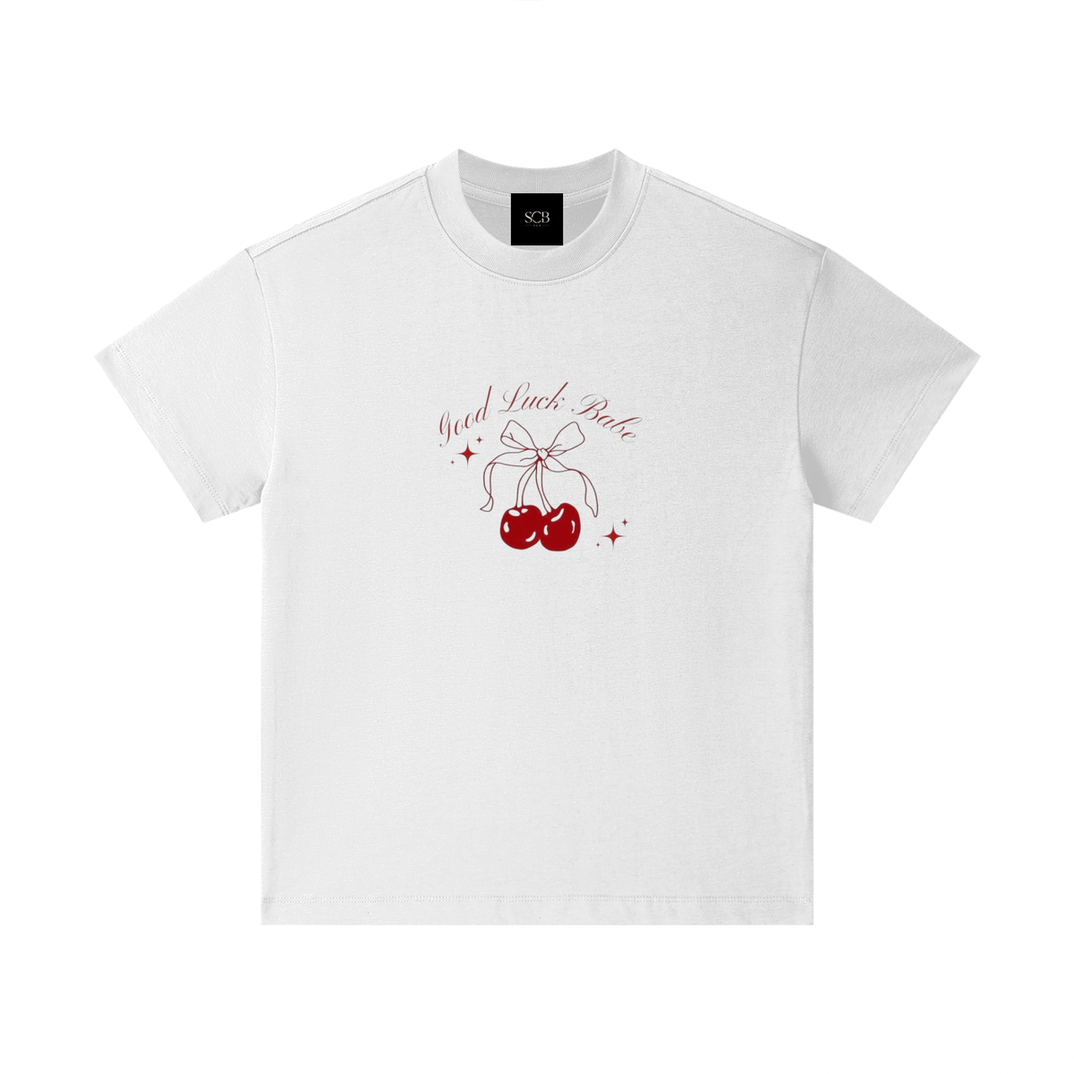 A white short-sleeve crewneck t-shirt with a graphic on the chest featuring red cherries tied with a bow, red sparkles, and the text 'You A F*ck B*tch' in a cursive font. A black neck label with the brand 'SCH' is visible inside the collar.